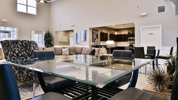 a dining room with a glass table and a living room